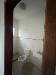 a bathroom with a toilet and a sink at Hotel Betel Rio Bonito in Estaçao Realengo