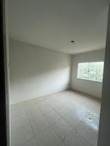 an empty room with a window and a tiled floor at Hotel Betel Rio Bonito in Estaçao Realengo