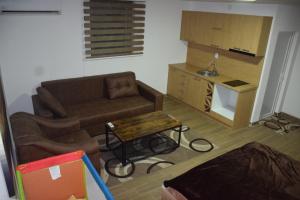a living room with a couch and a table at Komitski Konak & Spa in Plešanci