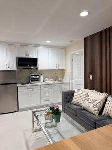 a living room with a couch and a kitchen at Sunset Beach Paradise Home in Sunset Beach