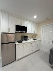 a kitchen with white cabinets and stainless steel appliances at Sunset Beach Paradise Home in Sunset Beach
