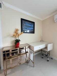a white office with a desk and a tv on the wall at Sunset Beach Paradise Home in Sunset Beach +5 photos