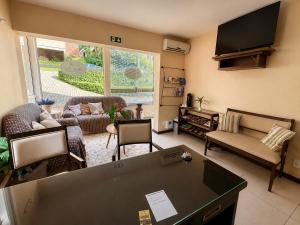 a living room with a flat screen tv at Pousada Nosso Lar in Gramado