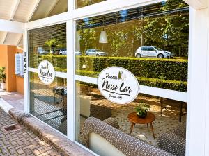 a window of a muesl cafe with stickers on it at Pousada Nosso Lar in Gramado