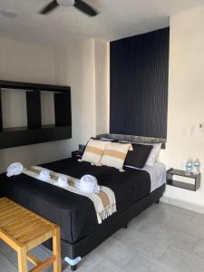 a bedroom with a large bed with a ceiling fan at PELÍCANOS Hotel & Beach Club in El Zapote