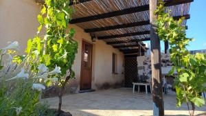 a porch of a house with a wooden pergola at Casa Verde con servizio gratuito E-Bike in Seneghe