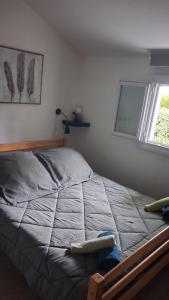 a bedroom with a large bed with a window at Parc résidentiel Les Moussaillons in Hourtin