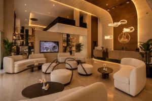 a waiting room with white chairs and tables at Luxury Night Hotel Al Yasmin in Riyadh