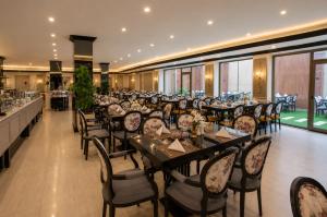a restaurant with tables and chairs in a room at Luxury Night Hotel Al Yasmin in Riyadh