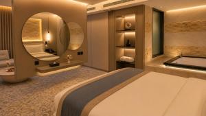 a bedroom with a bed and a tub and a mirror at Luxury Night Hotel Al Yasmin in Riyadh