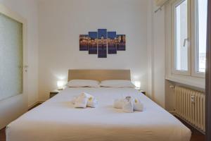 a bedroom with a white bed with towels on it at Free WiFi Netflix Settefontane Elegant Suite in Trieste
