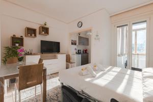 a white room with a bed and a dining room at Free WiFi Netflix Settefontane Elegant Suite in Trieste