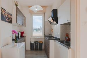 a small kitchen with a sink and a window at Free WiFi Netflix Settefontane Elegant Suite in Trieste