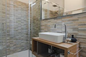 a bathroom with a sink and a shower at Free WiFi Netflix Settefontane Elegant Suite in Trieste +9 photos