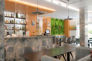 a restaurant with tables and chairs and a bar at MiraMar Hotel in Shëngjin