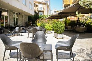 a group of chairs and tables in a patio at MiraMar Hotel in Shëngjin