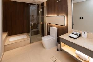 a bathroom with a toilet and a glass shower at Luxury Night Hotel Al Yasmin in Riyadh +43 photos