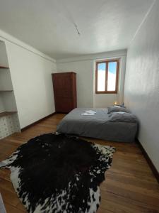 a bedroom with a bed and a black and white rug at Beau Refuge du Galibier in Le Monêtier-les-Bains +6 photos
