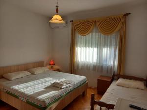 a bedroom with a large bed and a window at Villa Marija in Struga