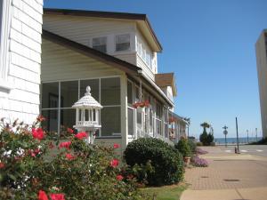a house with a gazebo on the side of it at Cutty Sark Efficiencies and Historic Cottage's in Virginia Beach