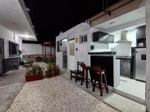 a kitchen with a table and some stools in it at Departamentos Oasis in Champotón