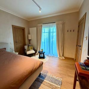 a bedroom with a bed and a large window at La Petite Suite - Unique Guesthouse in Schilde +9 photos