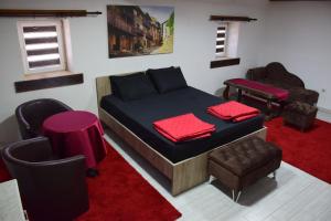 a bedroom with a bed and a table and chairs at Komitski Konak & Spa in Plešanci