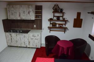 a kitchen with a sink and a table and chairs at Komitski Konak & Spa in Plešanci +33 photos