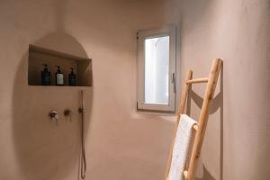 a bathroom with a shower with a ladder and a window at Villa AELIA by LLB Mykonos - 2BDR - Sea & Sunset view in Mikonos