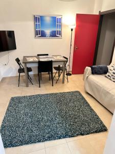 a living room with a table and a red door at Petriccioli seaview in Lerici