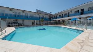 a large swimming pool in front of a building at Damar Hotel Collection Valledupar in Valledupar
