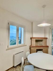 a dining room with a table and chairs and a fireplace at Tenuta Piccioni Relais,Pool and Spa in Colonnella +26 photos