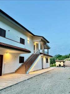 a house with a staircase on the side of it at Tenuta Piccioni Relais,Pool and Spa in Colonnella