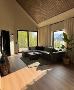 a living room with a couch and a table at LyNora - A private fjord retreat in Indre Ravelseidet