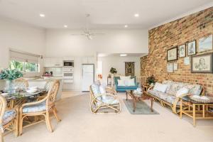 a living room with a brick wall at Harbour Creek in Ulladulla