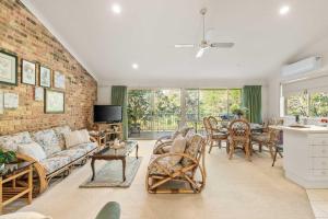a living room with a brick wall at Harbour Creek in Ulladulla