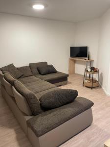 a living room with a couch and a flat screen tv at Ferienwohnung Moor in Wickede (Ruhr)