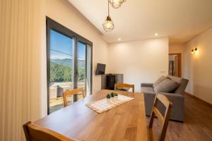 a living room with a table and a couch at Terreiro da Serra in Rio Caldo
