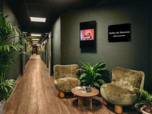 a hospital hallway with two chairs and a table at ibis Paris Bastille Opera in Paris