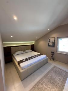 a bedroom with a large bed in a attic at NOMA Rooms Murter in Murter