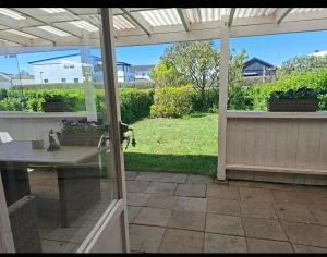 a patio with a table and a view of a yard at Villa Glumslov in Landskrona +6 photos