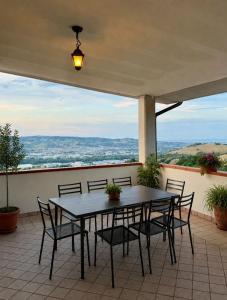 a table and chairs on a patio with a view at Tenuta Piccioni Relais,Pool and Spa in Colonnella