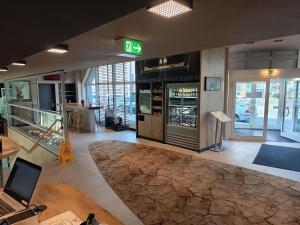 a lobby of a store with a laptop on a table at ibis Heidelberg Hauptbahnhof in Heidelberg