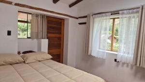 a bedroom with a bed and a window at Casa Hospedaje Saywa in Lamay