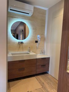 a bathroom with a sink and a mirror at NOMA Rooms Murter in Murter