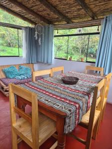 a dining room table with a table cloth on it at Casa Hospedaje Saywa in Lamay