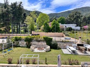a backyard with a fire pit in the grass at green & blue villa in Glykadi