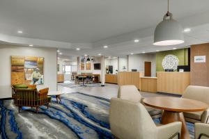 a lobby with a waiting area and a table and chairs at Fairfield Inn by Marriott Ponca City in Ponca City