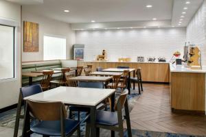 a restaurant with tables and chairs and a counter at Fairfield Inn by Marriott Ponca City in Ponca City