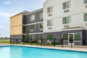 a building with a swimming pool in front of a building at Fairfield Inn by Marriott Ponca City in Ponca City